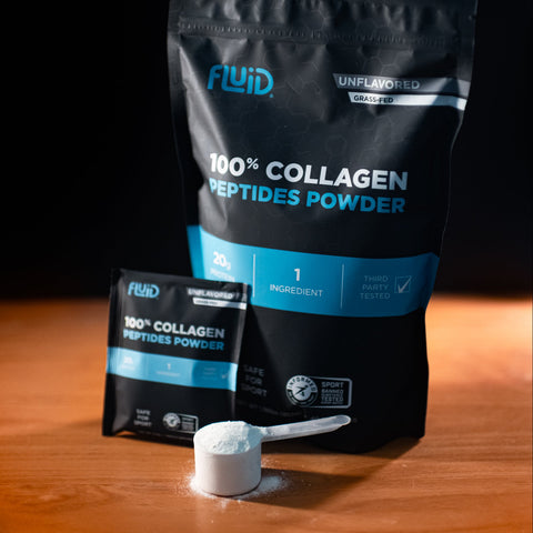 Black package of Fluid 100% Collagen Peptides Powder on a wooden surface with a dark background