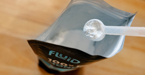 Fluid 100% Creatine Monohydrate powder scoop