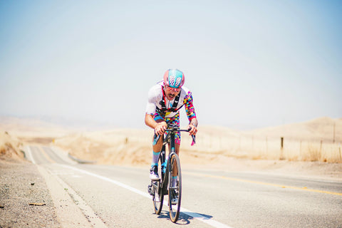 Tyler Pierce, also known as "The Vegan Cyclist," rides his bicycle down a country road in an ultra endurance bike race.