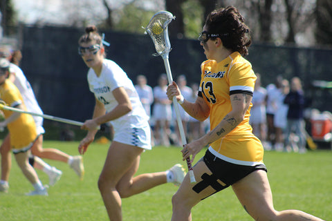 Natalia Ogando in action playing in a lacrosse match for Felician University