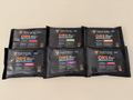 Six black tactical ORS packets arranged on a beige background