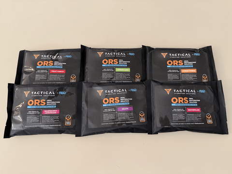 Six black tactical ORS packets arranged on a beige background