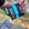 Single serving Fluid whey protein isolate being poured into water bottle
